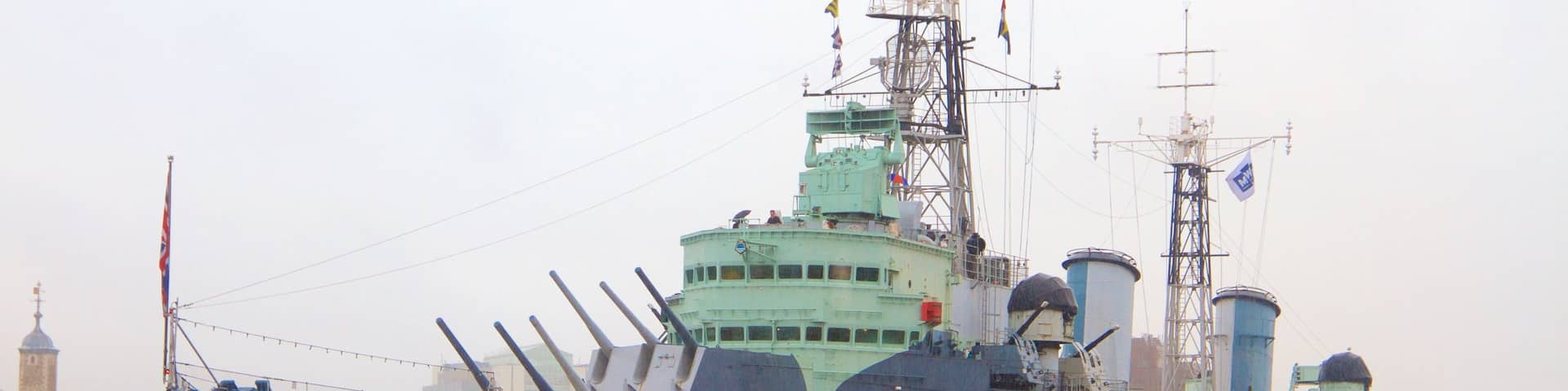HMS Belfast featuring military items and a river or creek