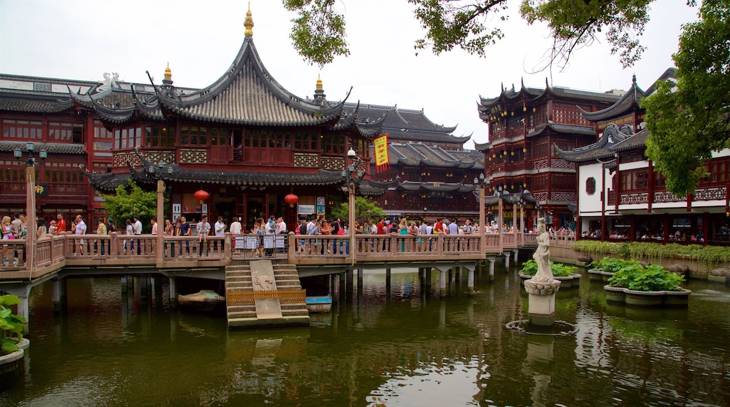 Shanghai showing a lake or waterhole and heritage elements as well as a large group of people