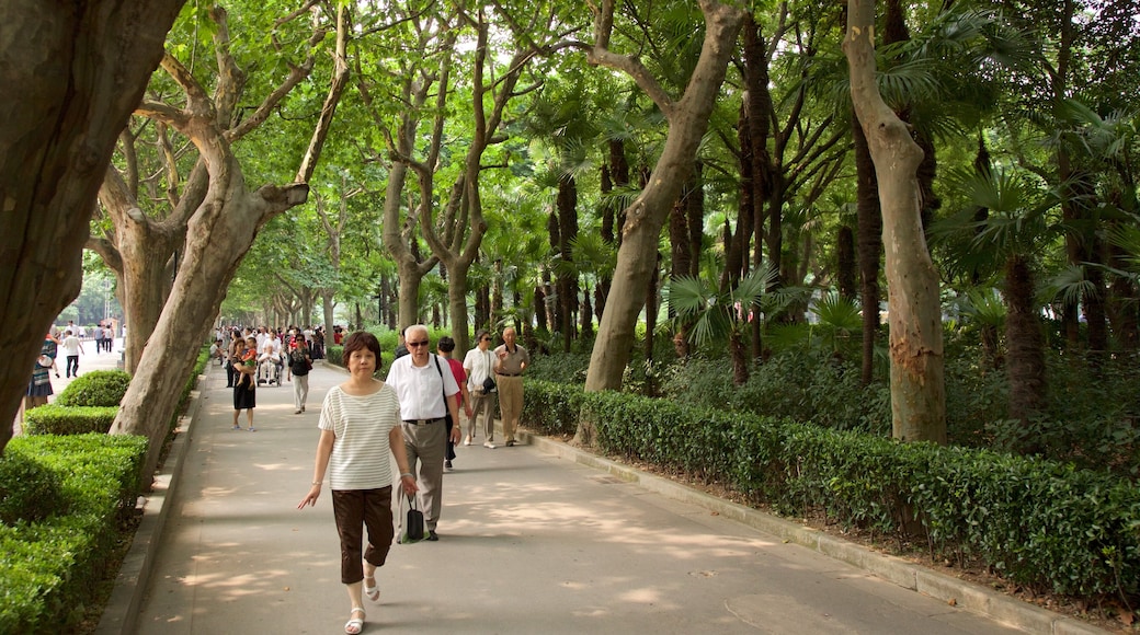 Fuxing Park featuring a garden as well as a small group of people