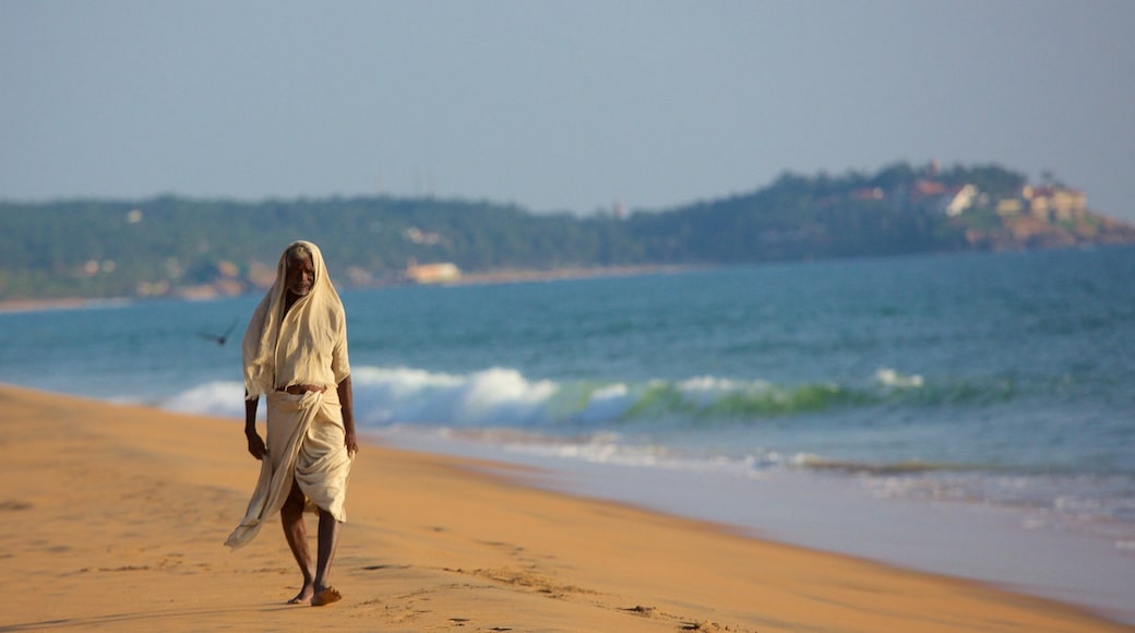 Thiruvananthapuram District featuring a sandy beach as well as an individual male