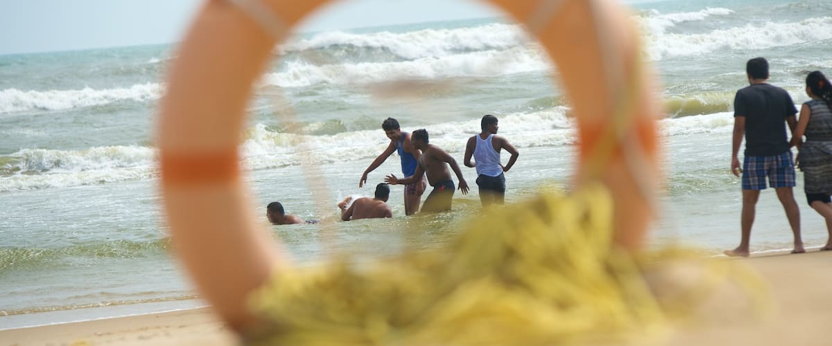 Pondicherry showing a beach as well as a small group of people