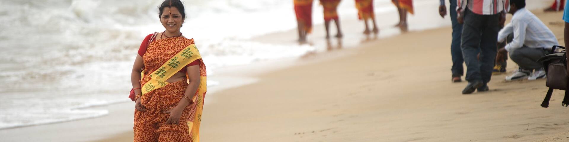 Mamallapuram Beach featuring a sandy beach as well as an individual femail