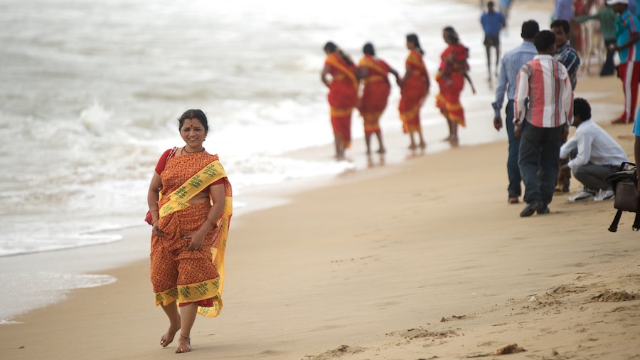 Mamallapuram Beach showing a sandy beach as well as an individual female