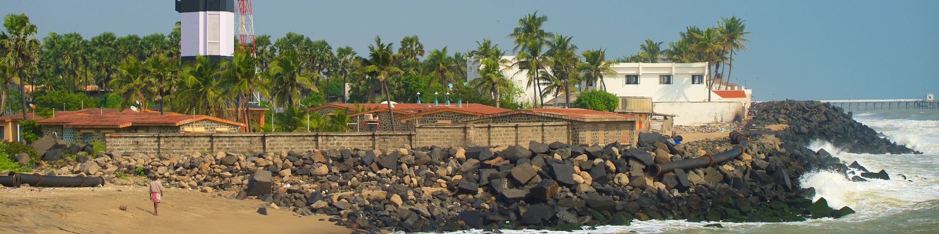 Pondicherry Lighthouse featuring a sandy beach, a lighthouse and rocky coastline