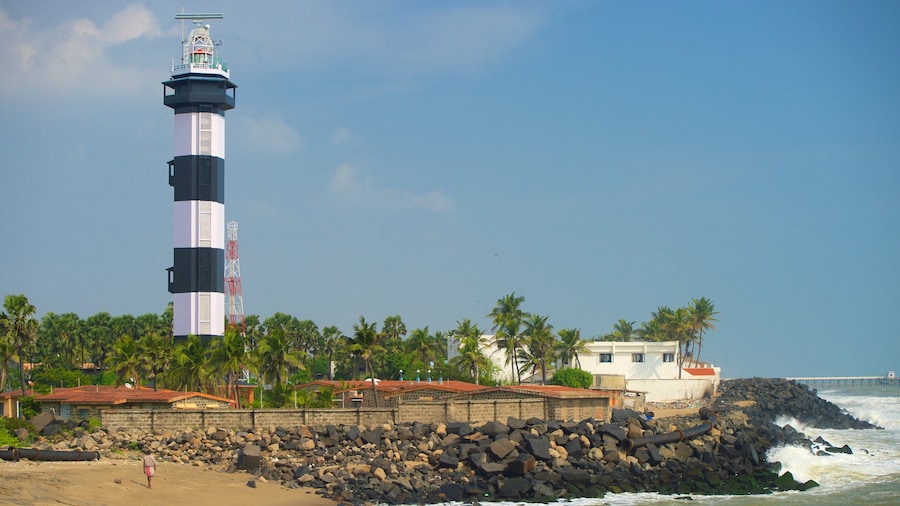 Pondicherry Lighthouse featuring a lighthouse, rocky coastline and a sandy beach