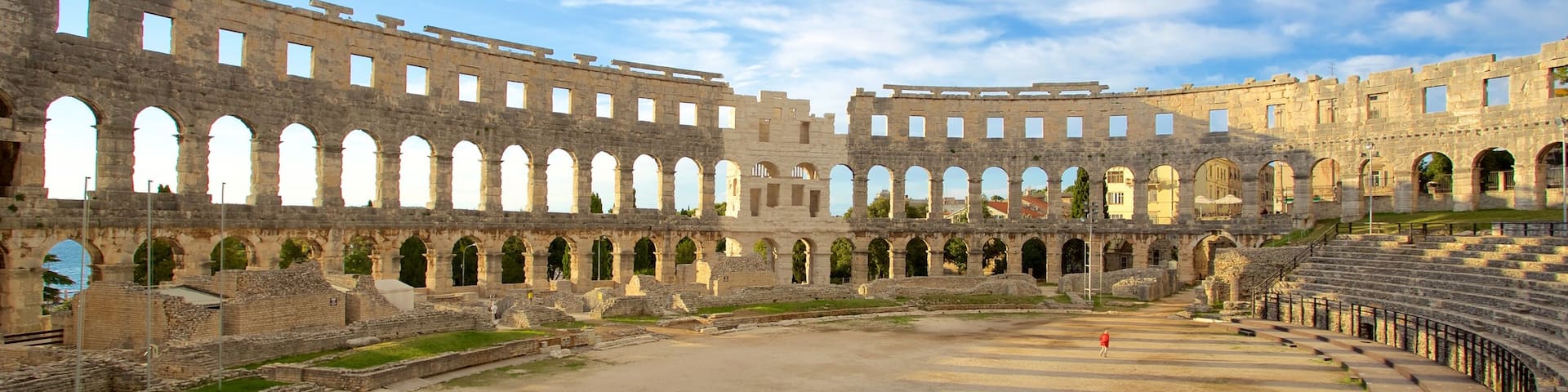 Pula Arena which includes a monument, heritage elements and building ruins