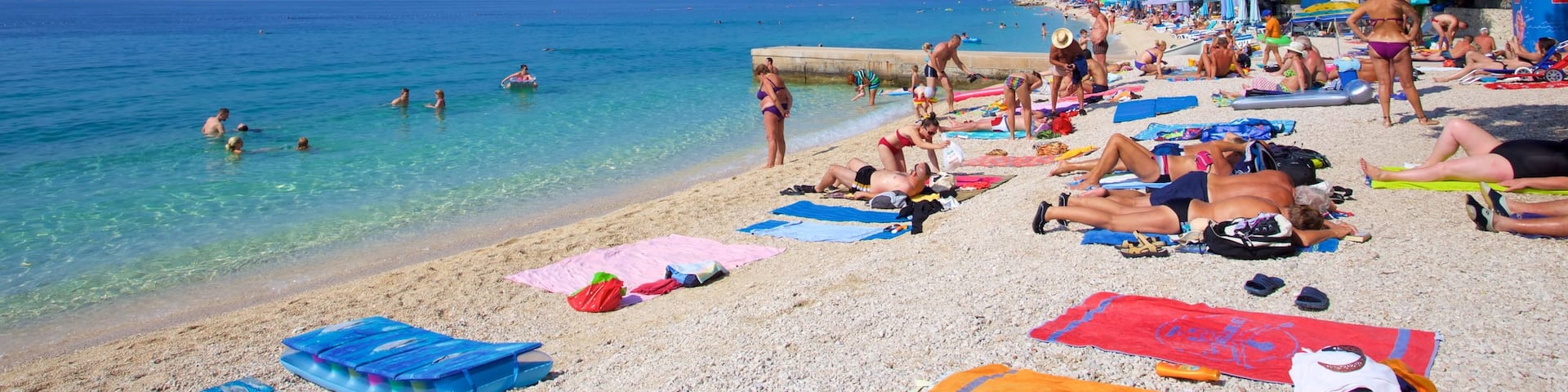 Baska Voda Beach which includes a pebble beach as well as a small group of people
