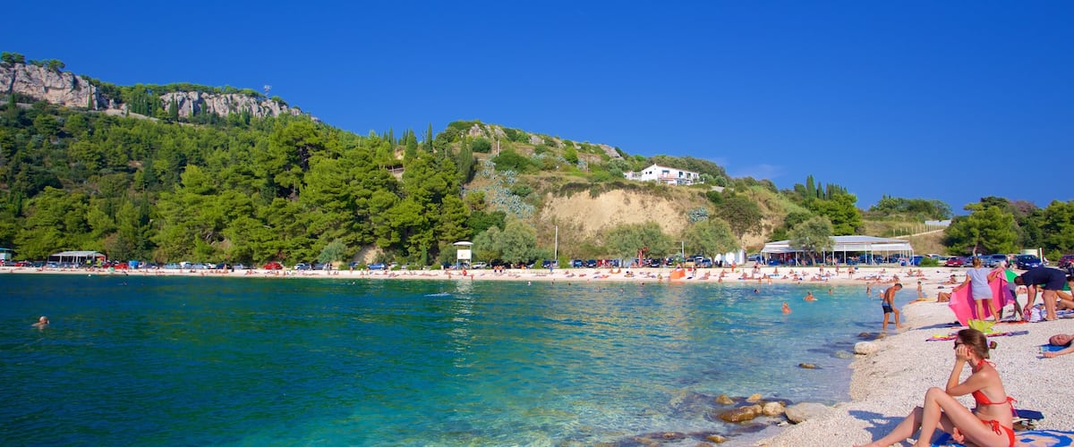 Playa de Kasuni mostrando una playa y vistas generales de la costa y también una mujer