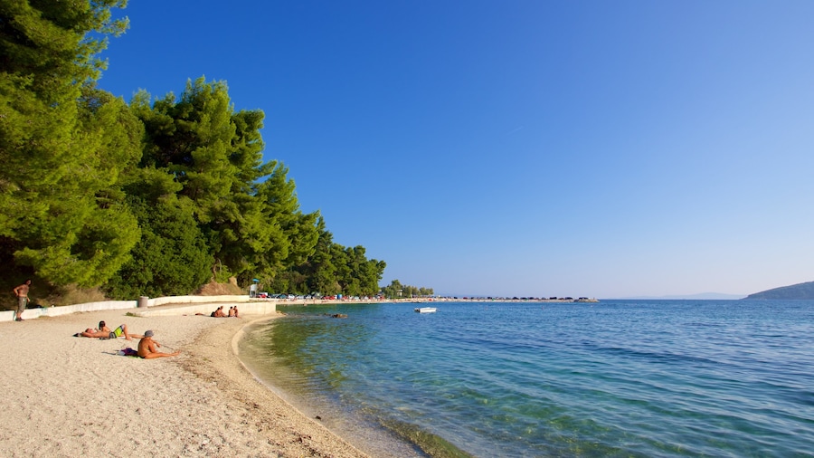 Kasuni Beach which includes general coastal views and a beach as well as a small group of people