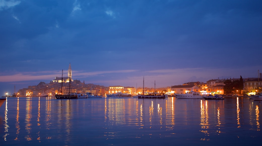 Rovinj Harbour which includes night scenes and a bay or harbour