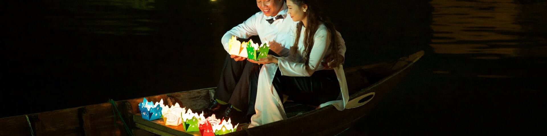 Hoi An featuring kayaking or canoeing and night scenes as well as a couple