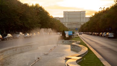 Palace of the Parliament showing street scenes, a fountain and a sunset