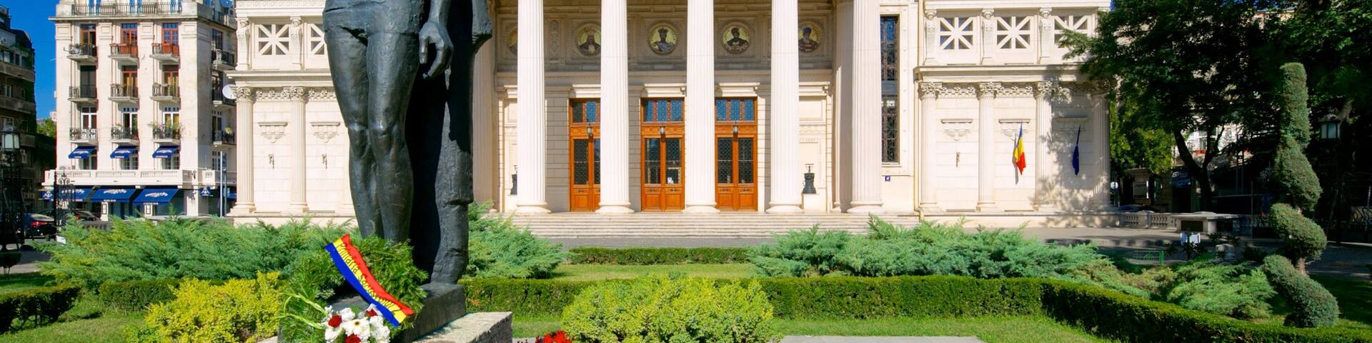 Romanian Athenaeum featuring theatre scenes, a statue or sculpture and heritage architecture