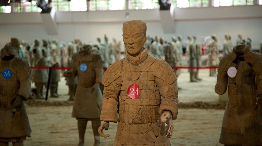 Terracota Army which includes a statue or sculpture and interior views