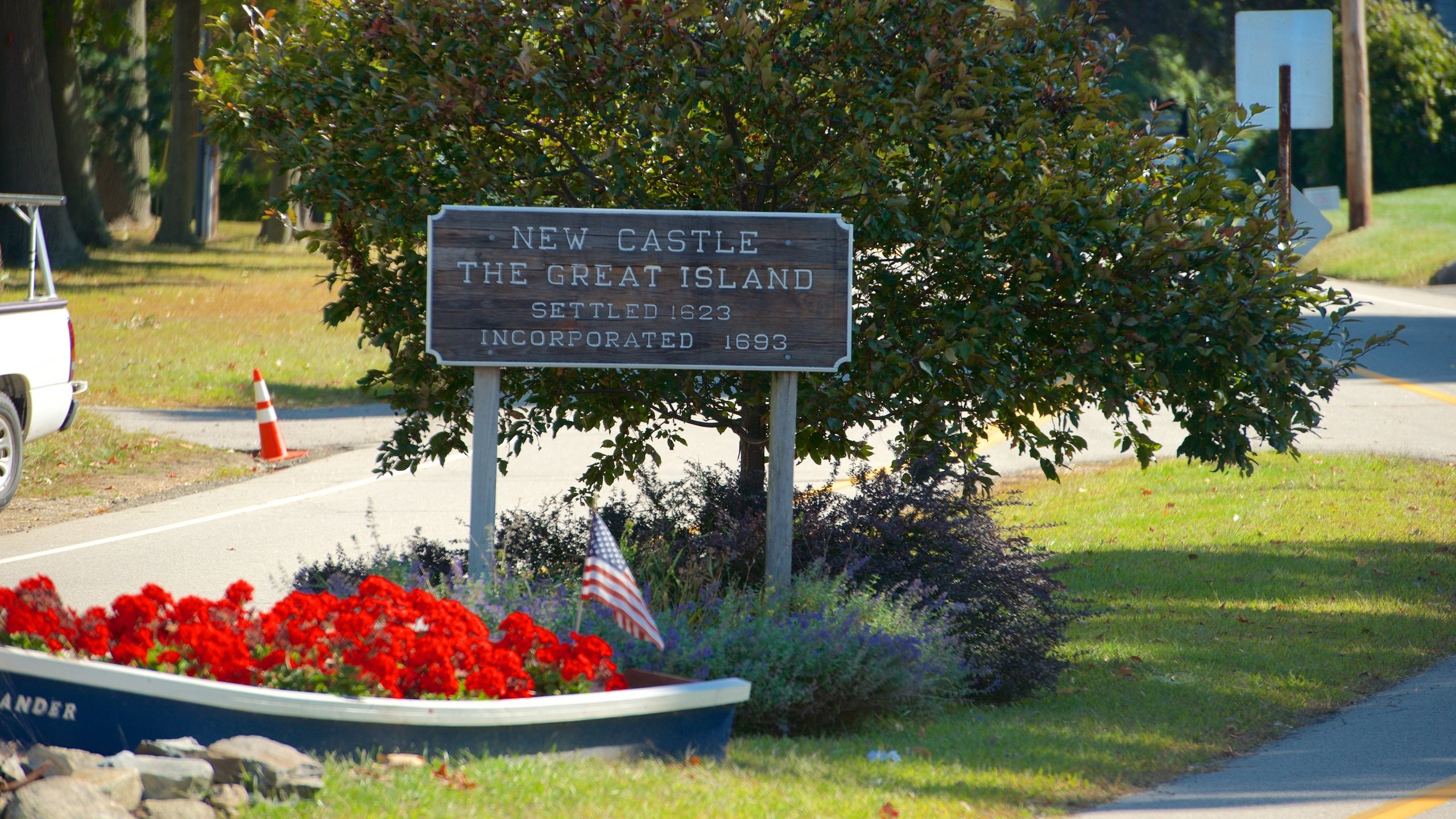New Castle which includes signage and flowers