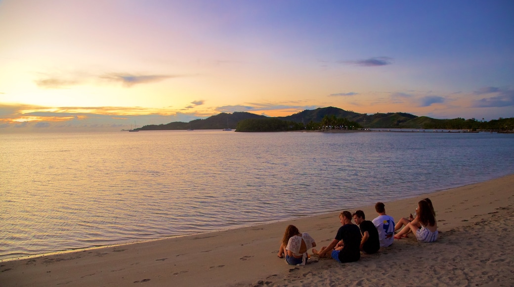 Musket Cove Marina showing a sunset, mountains and a beach