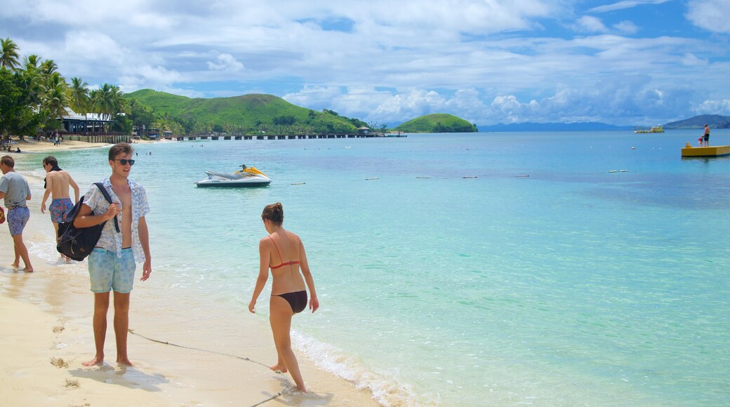 Mana Island showing a sandy beach as well as a small group of people