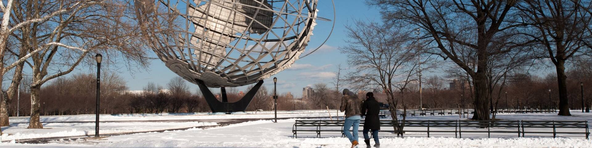 Corona featuring snow and a statue or sculpture as well as a couple