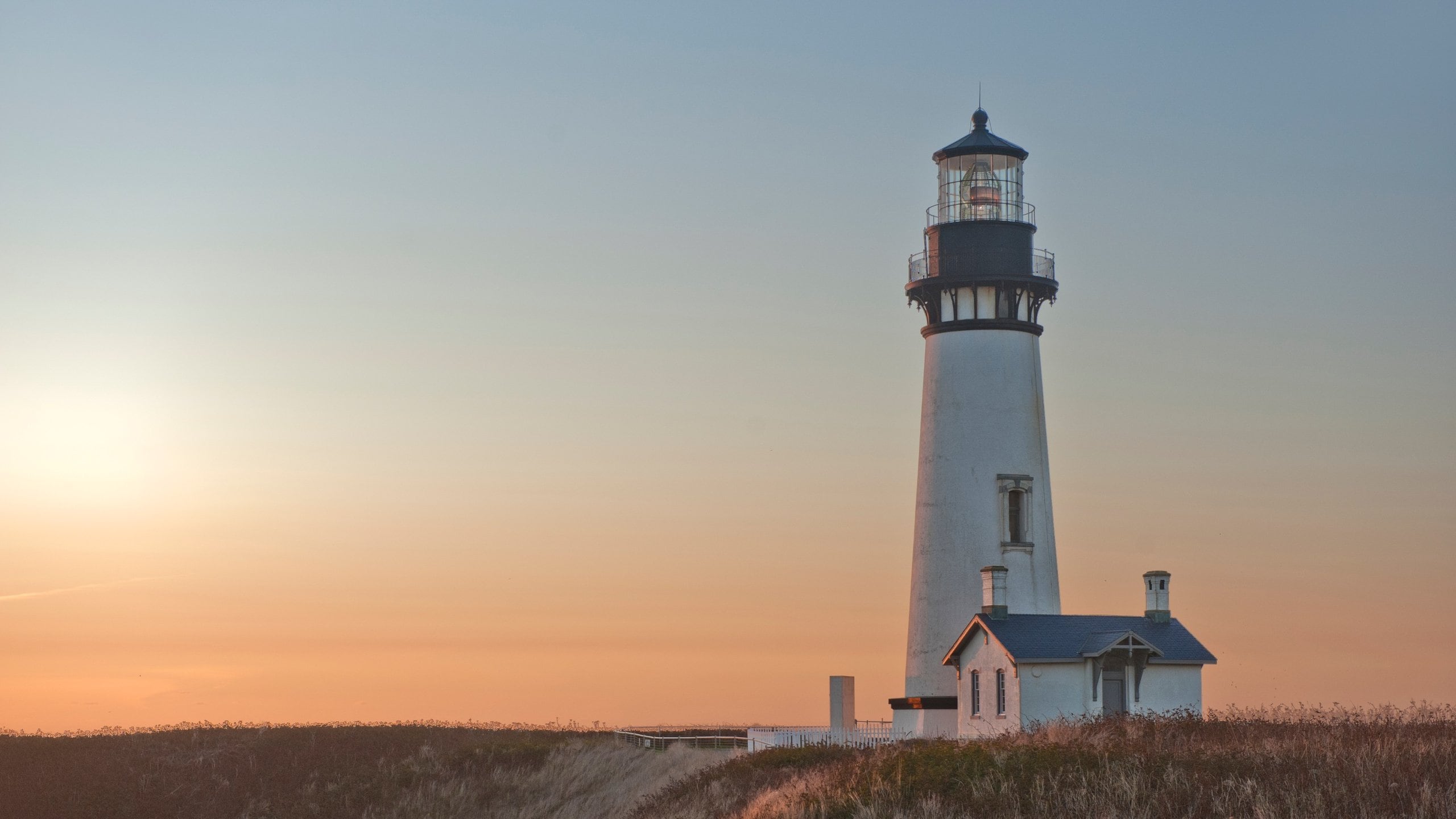 Newport featuring a lighthouse and a sunset