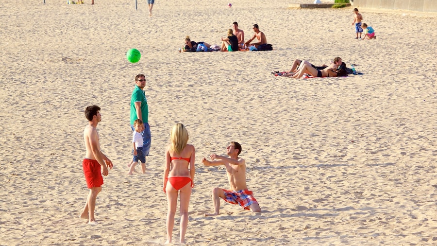 Minimes Beach featuring a sandy beach as well as a small group of people