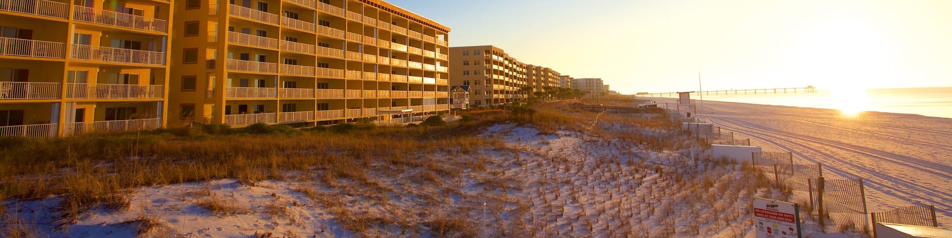 Fort Walton Beach showing a sandy beach, a hotel and a sunset