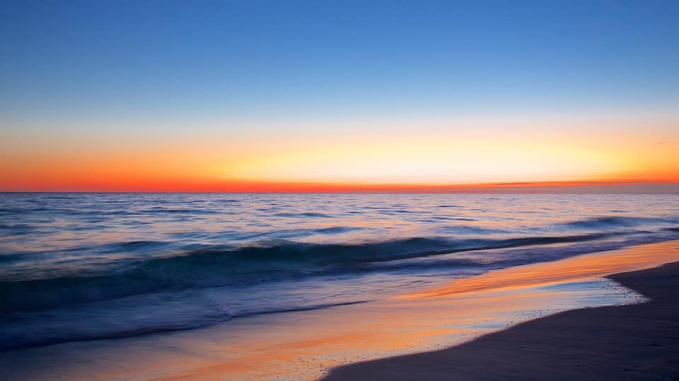 Okaloosa Island showing a sandy beach and a sunset