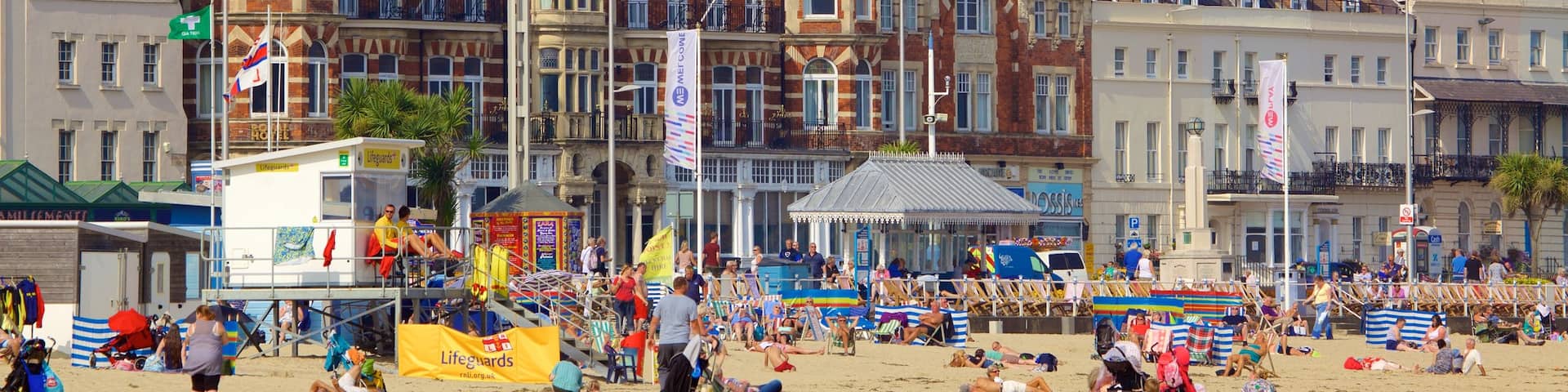 Weymouth Beach featuring a sandy beach as well as a large group of people