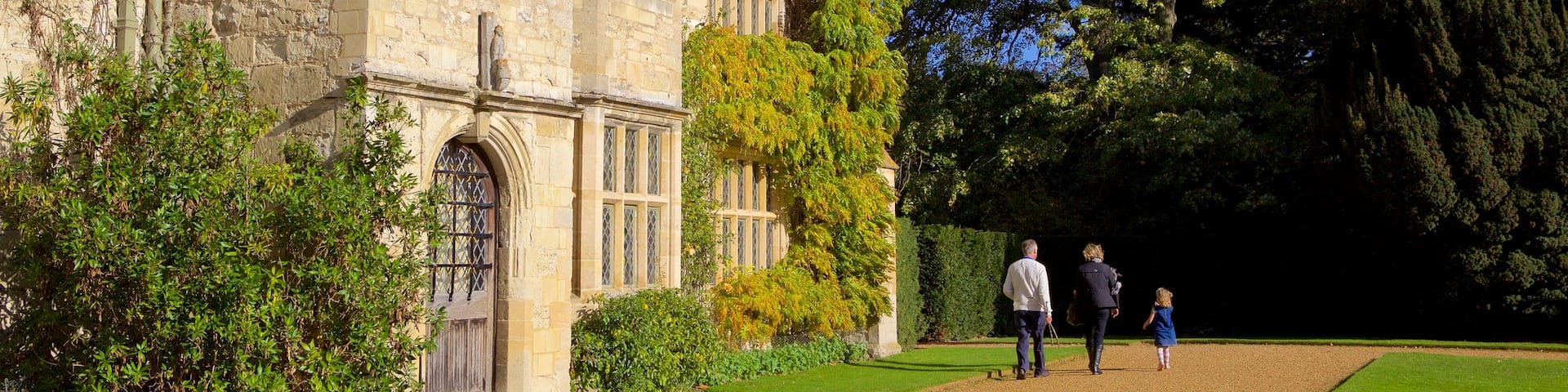 Anglesey Abbey showing heritage elements and heritage architecture as well as a family