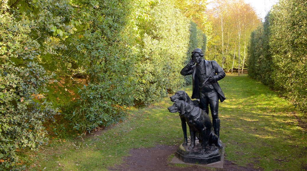 Anglesey Abbey which includes a statue or sculpture and a park