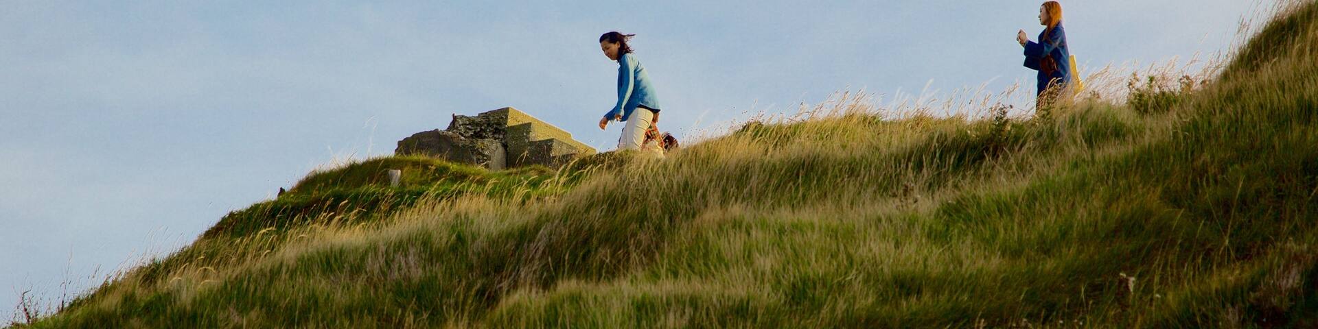 Lulworth Cove Beach which includes tranquil scenes as well as a small group of people