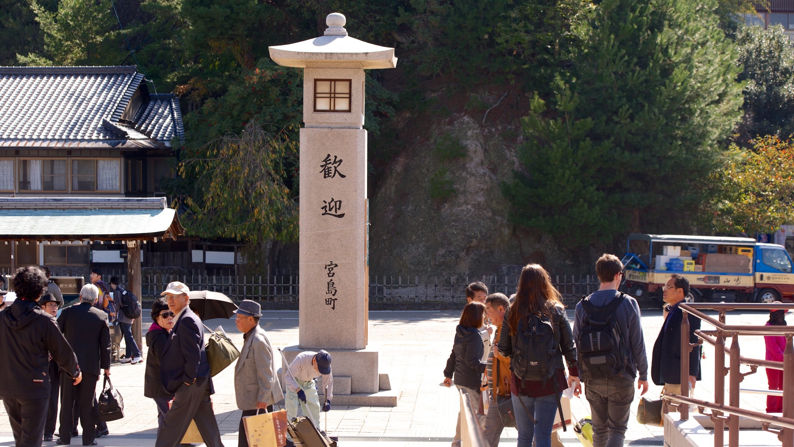 Hatsukaichi which includes a monument as well as a small group of people