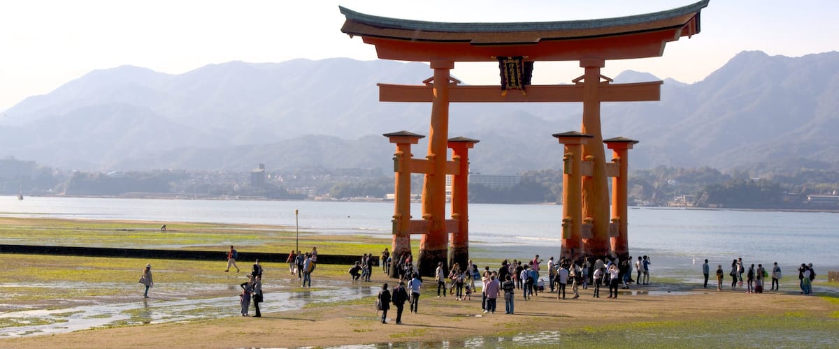 Hiroshima featuring heritage elements and a lake or waterhole as well as a large group of people