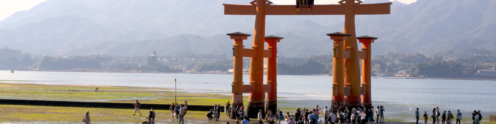 Hiroshima featuring heritage elements and a lake or waterhole as well as a large group of people