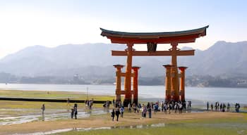 Hiroshima featuring heritage elements and a lake or waterhole as well as a large group of people