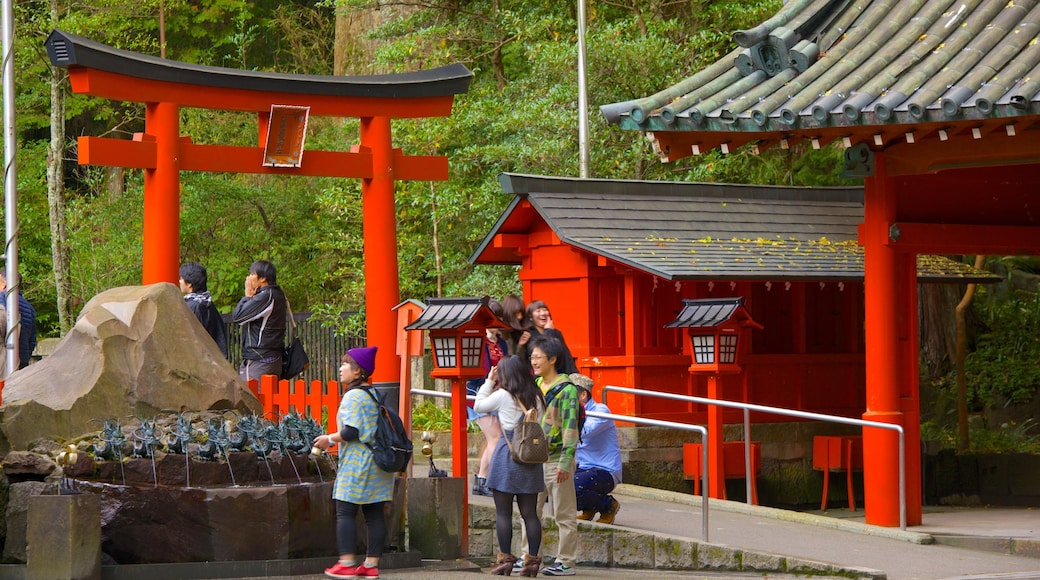 Hakone Shrine showing a temple or place of worship as well as a small group of people