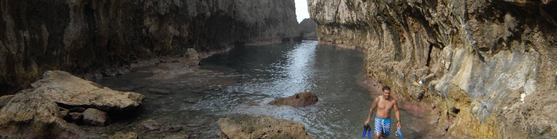 Matapa Chasm featuring a gorge or canyon and rugged coastline as well as an individual male