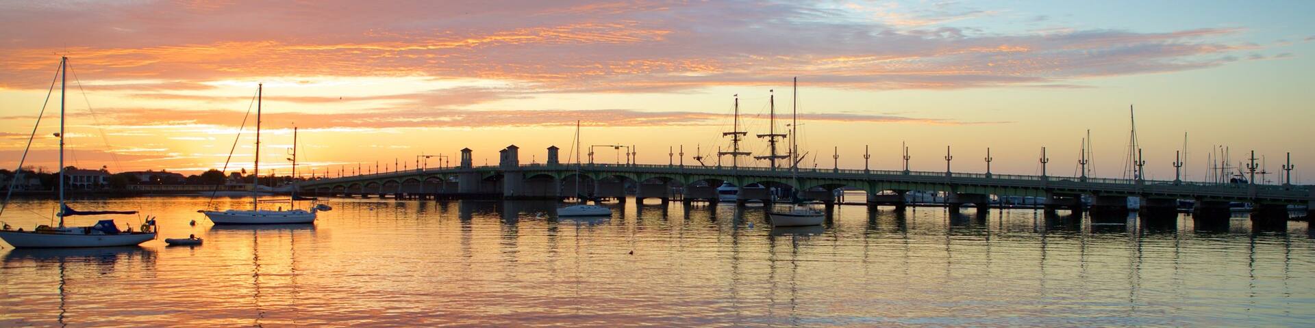 Bridge of Lions featuring a marina, general coastal views and a sunset