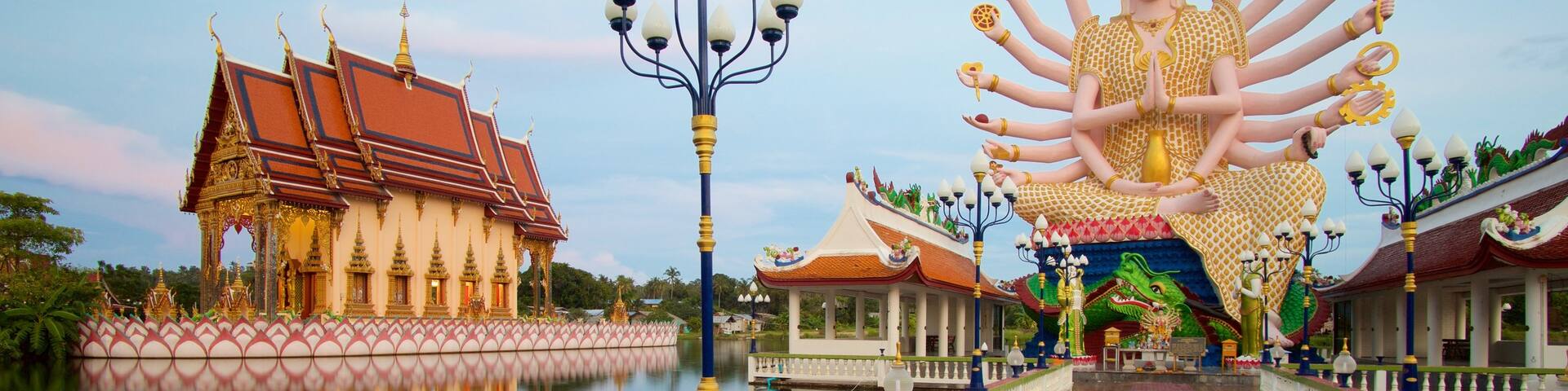 Wat Plai Laem featuring a temple or place of worship, religious elements and a statue or sculpture