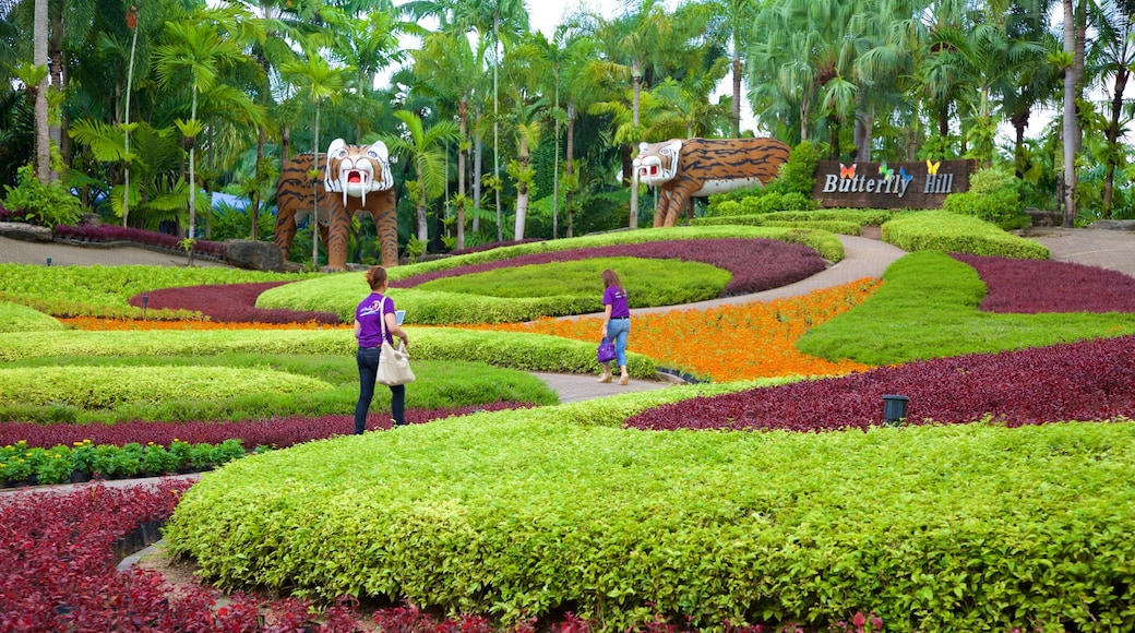 Nong Nooch Tropical Botanical Garden showing a park as well as a small group of people