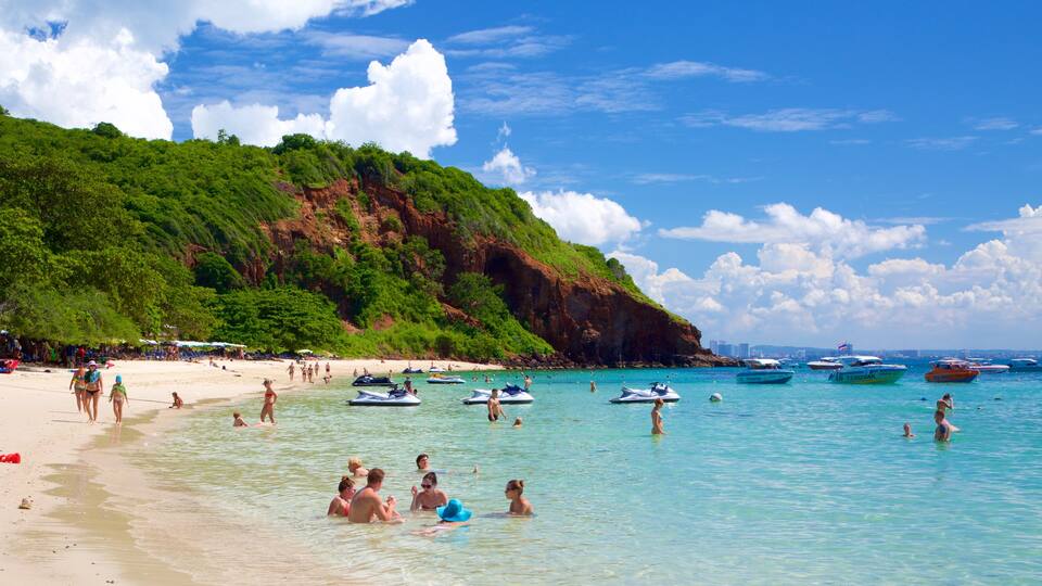 Nual Beach featuring a bay or harbor and swimming as well as a large group of people