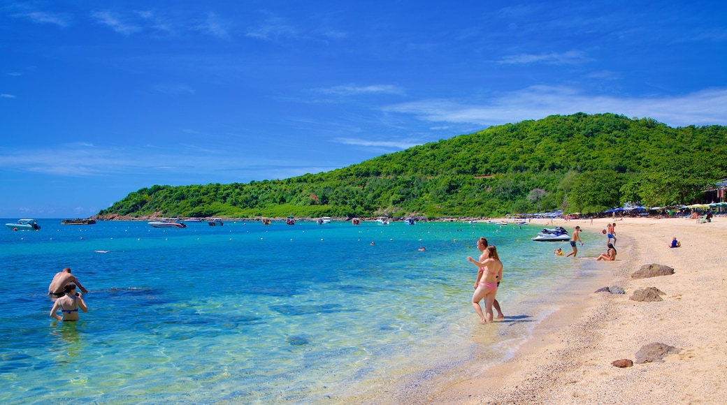 Nual Beach showing a beach as well as a large group of people