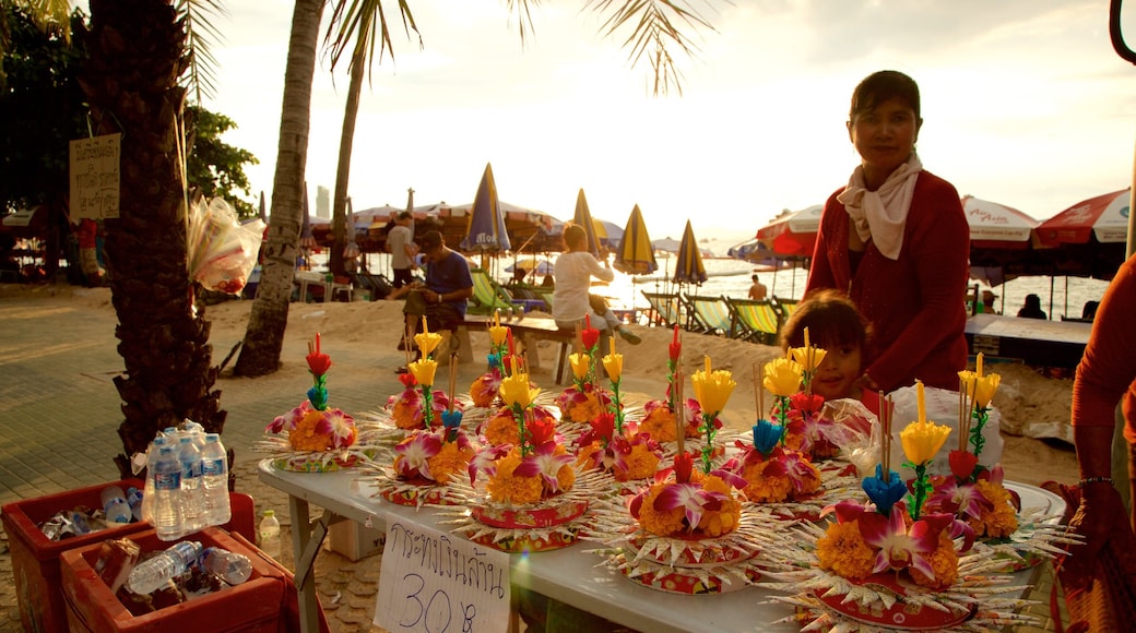 Pattaya Beach featuring a sunset and shopping as well as a small group of people