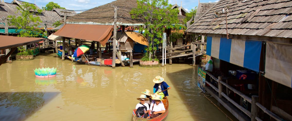 Pattaya Floating Market showing boating and a river or creek as well as a small group of people
