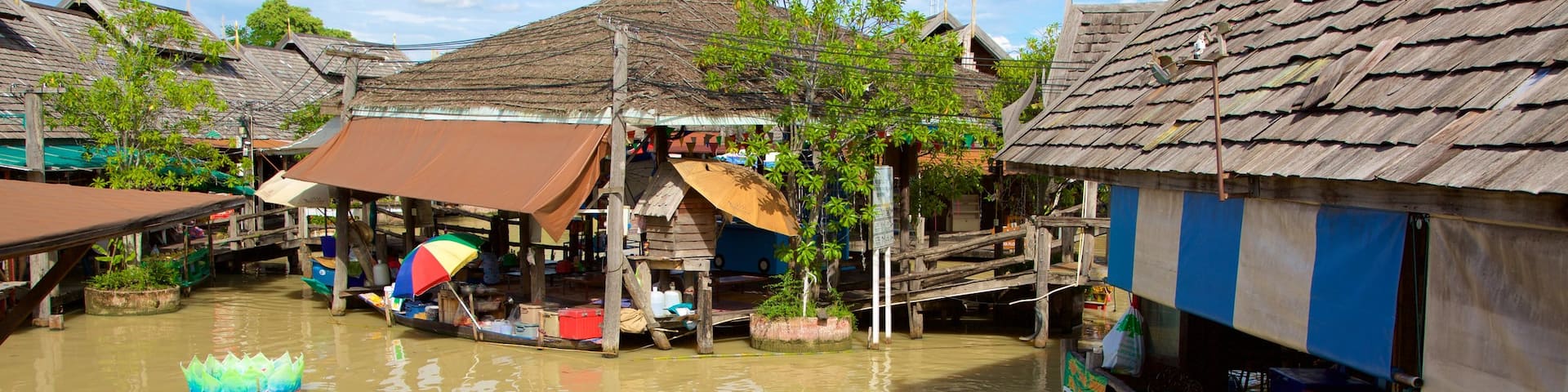 Pattaya Floating Market showing boating and a river or creek as well as a small group of people