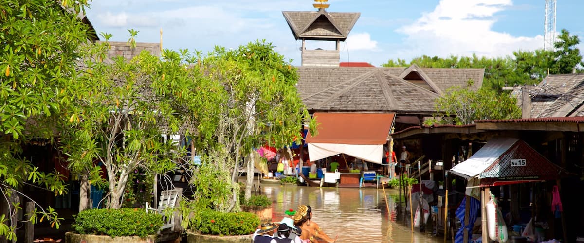 Pattaya Floating Market featuring a river or creek and boating as well as a large group of people