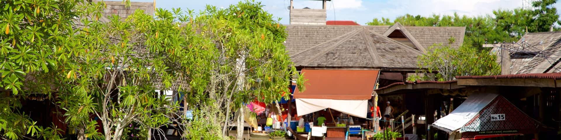 Pattaya Floating Market featuring a river or creek and boating as well as a large group of people