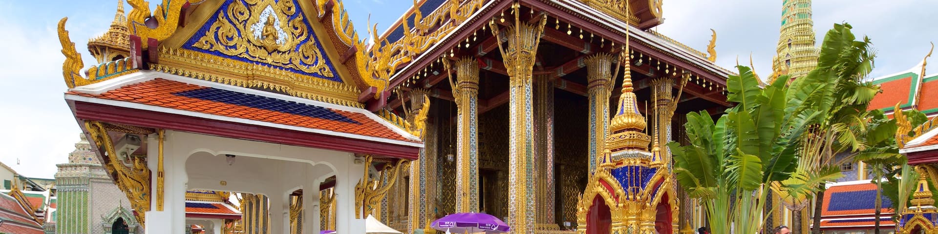 Temple of the Emerald Buddha which includes a temple or place of worship as well as a large group of people