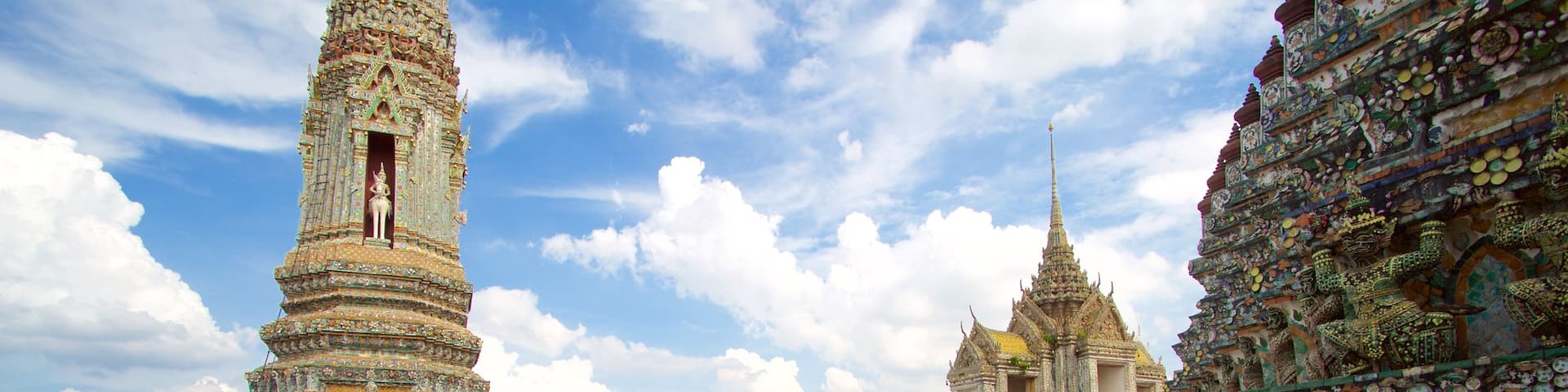 Wat Arun which includes a temple or place of worship as well as a large group of people