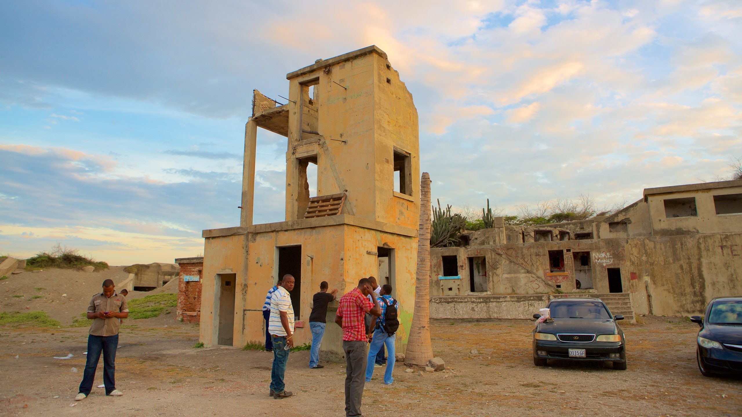 Kingston showing building ruins as well as a small group of people