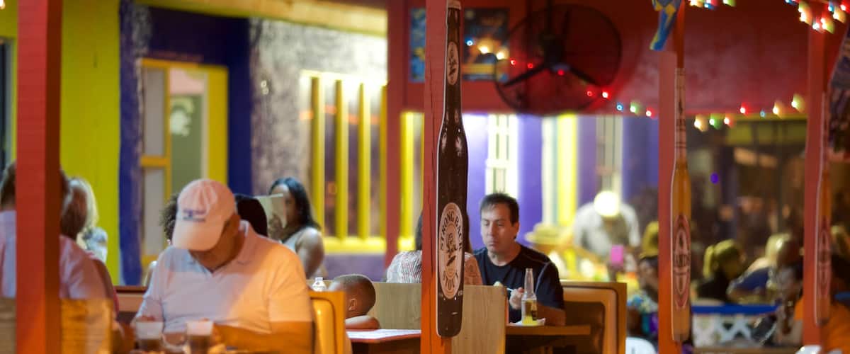 Smith Point showing night scenes, outdoor eating and a beach bar